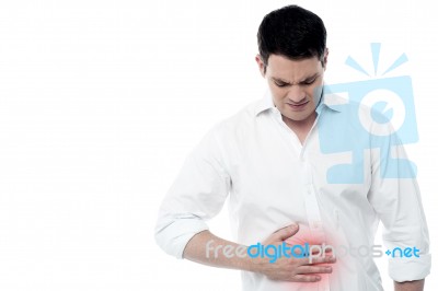Young Man With Strong Stomach Pain Stock Photo