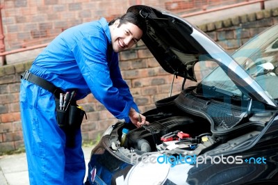 Young Mechanic Inspecting  Car Parts Stock Photo