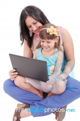Young Mother And Daughter Looking At Laptop.  Focus In The Mothe… Stock Photo