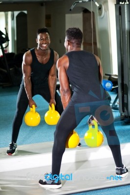 Young Muscular Man Working Out With Kettlebell Stock Photo