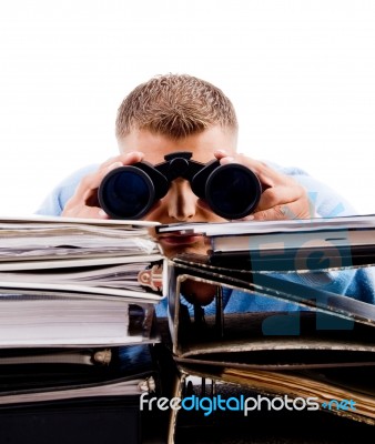 Young Professional In Office Looking Through Binocular Stock Photo