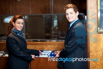 Young Receptionist Checking Records Stock Photo