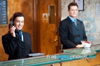 Young Receptionist Talking Phone Stock Photo