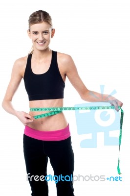 Young Slim Girl Measuring Her Waist Stock Photo