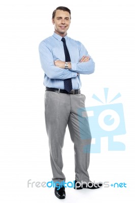 Young Team Leader Smiling Confidently With His Arms Crossed Stock Photo