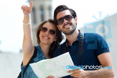 Young Tourist Couple Use Their Map And Pointing Where They Want Stock Photo