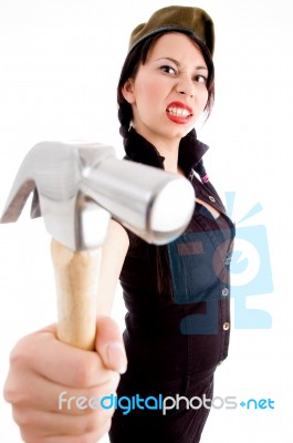 Young Violent Female Wearing Army Cap And Striking With Hammer Stock Photo