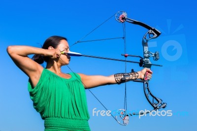 Young Woman Aiming Arrow Of Compound Bow Stock Photo