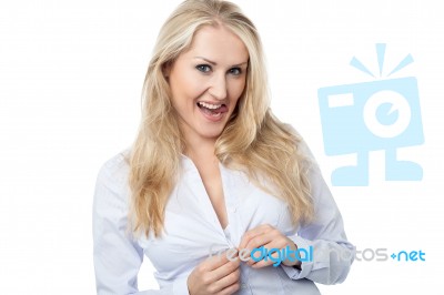 Young Woman Buttoning Her Shirt Stock Photo Young Woman Buttoning Her Shirt Stock Photo