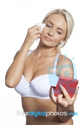 Young Woman Clean Face With Wet Wipes And Holding Mirror Stock Photo
