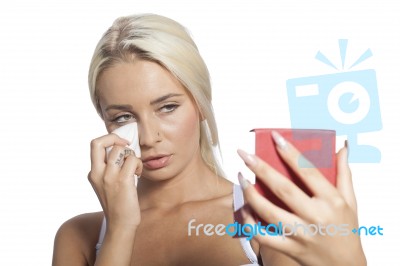 Young Woman Clean Face With Wet Wipes And Holding Mirror Stock Photo