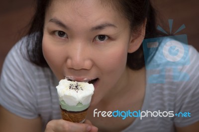Young Woman Eating Ice Cream Stock Photo