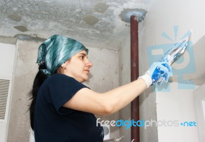Young Woman Gets Plaster Wall Stock Photo