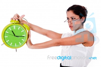 Young Woman Holding Clock Stock Photo