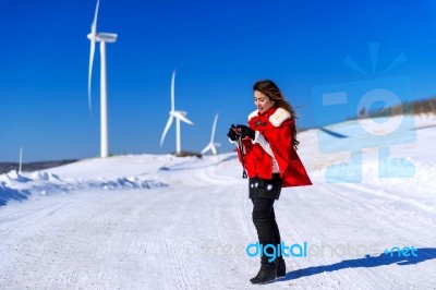 Young Woman Is A Happiness With Camera In Winter Of Sky And Winter Road With Snow And Red Dress Stock Photo