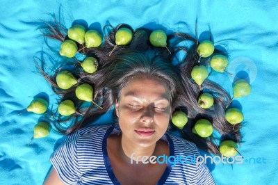 Young Woman  Lying Eyes Closed Pears In Black Hair Stock Photo