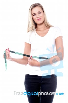 Young Woman Measuring Her Waistline Stock Photo