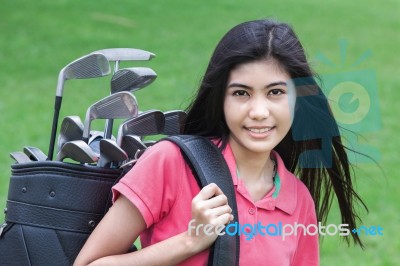 Young Woman On A Golf Course Stock Photo