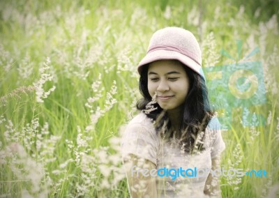 Young Woman On The Meadow With White Flowers On A Warm Summer Da… Stock Photo