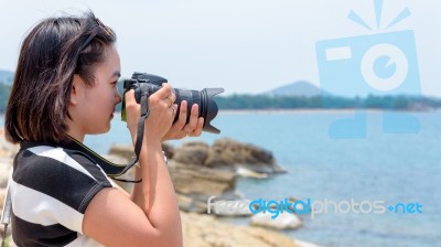 Young Woman Photography Near The Sea Stock Photo