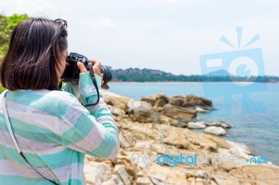 Young Woman Photography Near The Sea Stock Photo Young Woman Photography Near The Sea Stock Photo