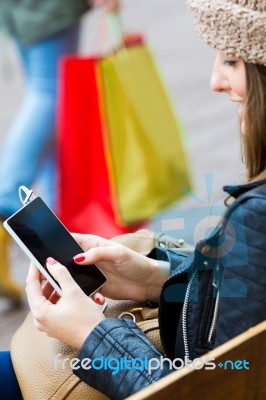 Young Woman Shopping In The City With His Mobile Phone Stock Photo