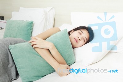 Young Woman Sleeping In Bed Stock Photo