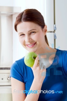 Young Woman Smiling Eating Apple Stock Photo Young Woman Smiling Eating Apple Stock Photo