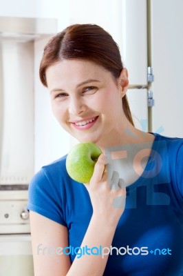 Young Woman Smiling Eating Apple Stock Photo