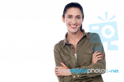 Young Woman Standing With Arms Crossed Stock Photo