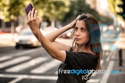Young  Woman Taking A Photo With Her Phone Stock Photo