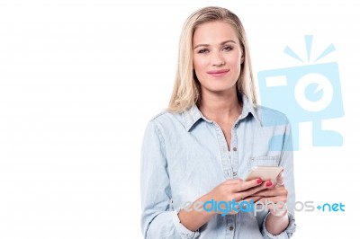 Young Woman Typing Text In Smart Phone Stock Photo