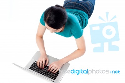 Young Woman Using Her Laptop, Top View Stock Photo