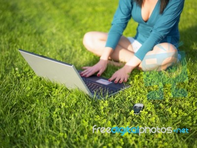 Young Woman Using Laptop And Mobile Phone Stock Photo