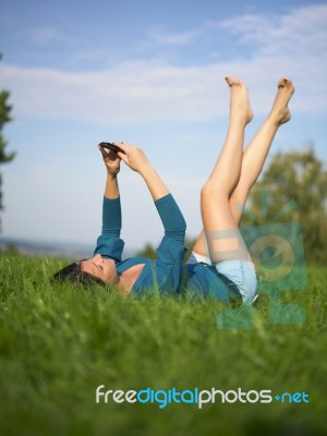 Young Woman Using Laptop In Park Stock Photo