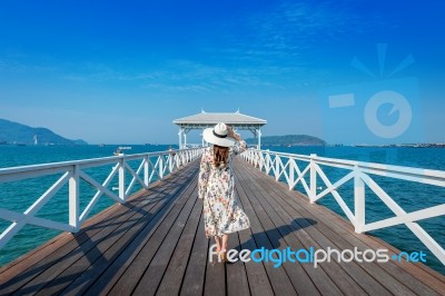 Young Woman Walking On Wooden Bridge In Si Chang Island, Thailand Stock Photo