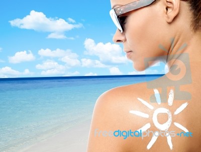 Young Woman With Suntan Lotion On Her Back Stock Photo