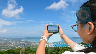 Young Women Taking Photograph With Mobile Phones Stock Photo