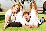 A Family Lying In Grass Stock Photo
