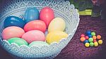 A Few Colorful Easter Eggs In A Blue Basket At The Green Garden With Candies Happy Easter Stock Photo