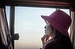A Girl Wearing A Hat Sitting In A Bus Was Watching The View Thro Stock Photo