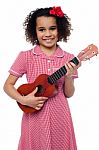 A Little Girl With A Toy Guitar Stock Photo