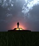 A Man Standing On The Roof Of The Car At Night Stock Photo