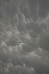 A Plane In Mammatus Clouds Stock Photo
