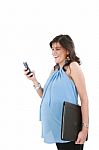 A Pregnant Woman Texting On Her Cell Phone With A Happy Expressi Stock Photo