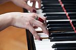 A Woman With Red Ring Playing Piano Stock Photo
