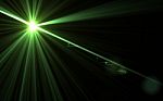 Abstract Lens Flare Green Light And Black Background Stock Photo