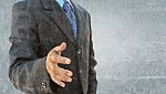 Abstract The Grunge Image Of A Businessman Hand To Shake Stock Photo