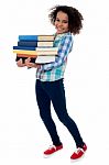 Active Young School Kid Carrying Books Stock Photo