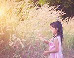 Adorable Little Girl Laughing In A Meadow - Happy Girl At Sunset Stock Photo